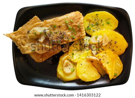 Top view of pan fried skate wings and potatoes baked with garlic . Traditional Spanish dish from Santurtzi. Isolated over white background