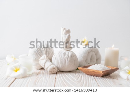 Spa herbal compressing ball with candle and orchid - beauty concept Royalty-Free Stock Photo #1416309410