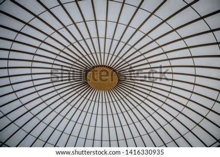 Glass decorative surface in building roof with metal frame, photo from below