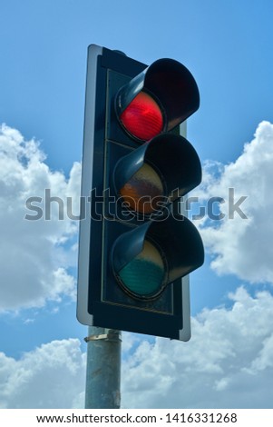 Traffic lamp on a summer sky
showing stop
                               