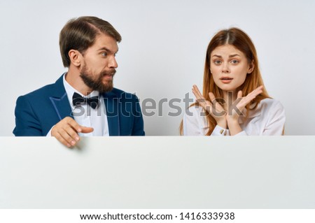 Business man in a suit next to a Whatman woman display paper stencil presentation