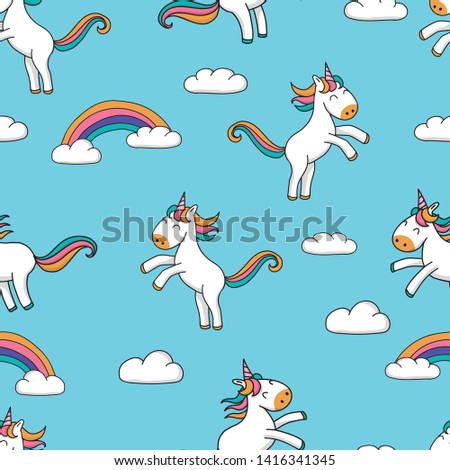 Seamless pattern with cute hand drawn cartoon unicorns and rainbow design on blue background - sweet repeat background great for textiles, banners, wallpapers