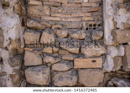Old wall, made of stones. It's a wall of the house with details. Outdoor closeup shot