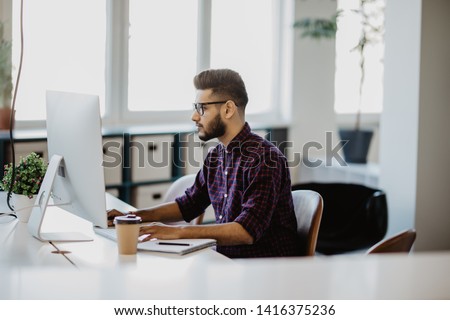 Indian Businessman working with papers and computer working at office Royalty-Free Stock Photo #1416375236