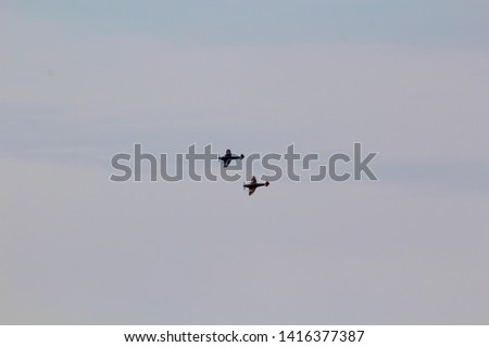 WWII Spitfire and Hurrican flying in formation banking left Royalty-Free Stock Photo #1416377387