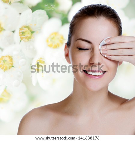 Young beautiful girl cleans the eye make-up Royalty-Free Stock Photo #141638176
