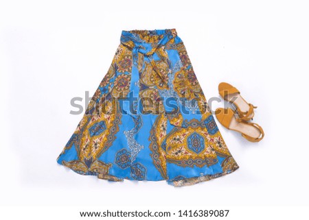 
Stylish summer flower skirt with shoes isolated on white background.
