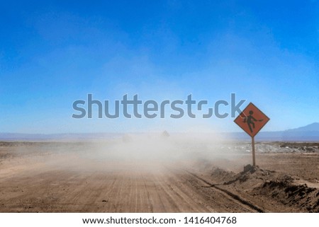 Scenic desert highway with yellow road sign at Atacama, road trip and travel concept, Chile