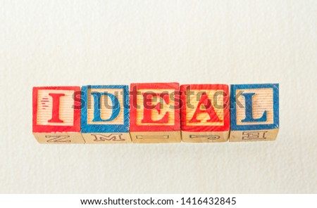 The term ideal visually displayed on a white background using colorful wooden blocks image with copy space in landscape format