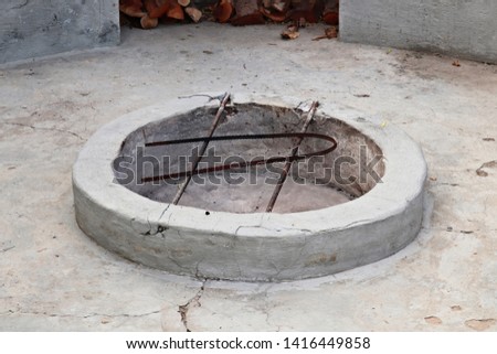 A cement fire pit which is used to cook meat (braai).