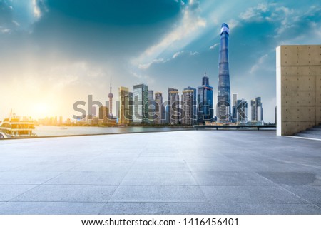 Shanghai skyline and modern city skyscrapers with empty floor at sunset,China