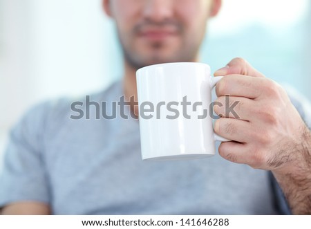 Close-up of male hand holding mug