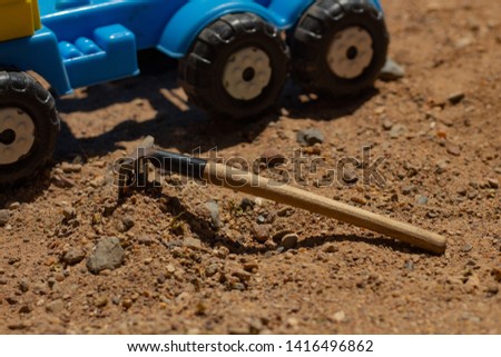 rake on the ground and car wheels