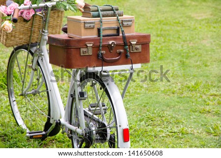 Vintage bicycle on the field with a bag