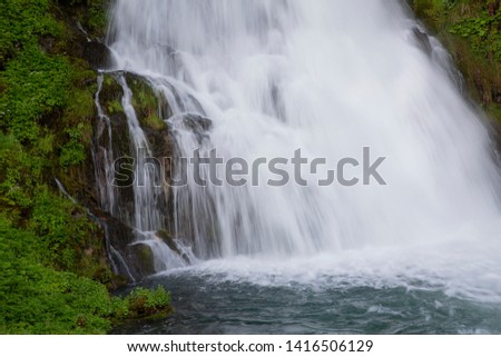 Jaun Waterfall inFribourg Switzerland early morning. Cool water splashes and energetic field.