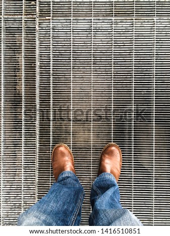 standing on a metal grate