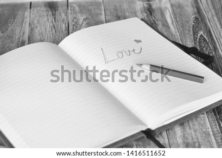 Love romantic message with red heart in scrapbook
