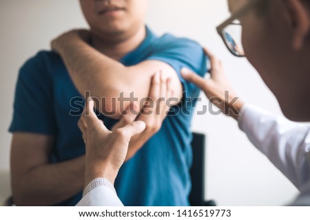 Physical therapists are checking patients elbows at the clinic office room. Royalty-Free Stock Photo #1416519773