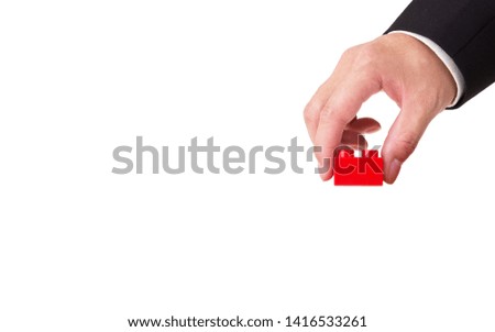 hand holding a plastic block isolated on white background