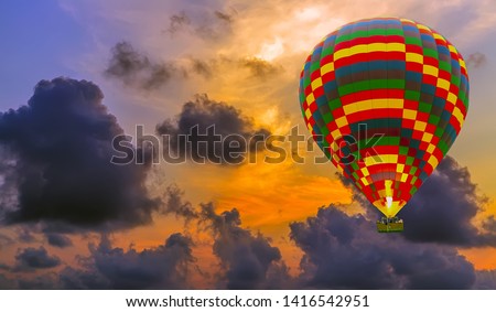 Colorful hot air balloons flying in the sky with cloud before sunset. Travel concept tropical sunset sky landscape. Breathtaking cloudy colorful sky background.