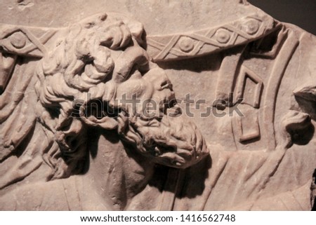 A beautiful ancient Roman stone low relief decoration on the wall.