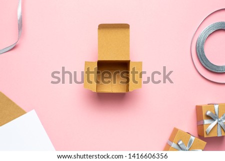 Open empty gift box on pink table. Colorful Gift box with ribbon bow present on holiday