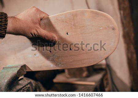 A cool skateboard is made up of his own hands