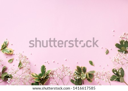 Small white gypsophila flowers on pastel pink background. Women's Day, Mother's Day, Valentine's Day, Wedding concept. Flat lay. Top view. Copy space.