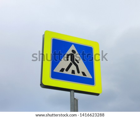 Crosswalk traffic sign with isolated on cloudy sky background 