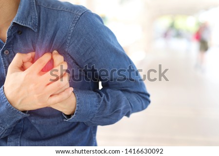 Men have chest pain caused by heart disease, heart attack, heart leakage, coronary heart disease. Royalty-Free Stock Photo #1416630092