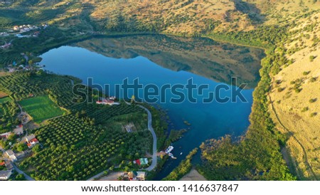 Aerial drone panoramic photo of famous natural lake of Kournas with amazing colours and unique nature surrounded by mountains, Chania prefecture, Crete island, Greece
