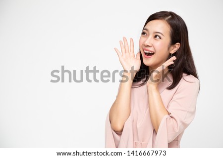 Portrait of excited screaming young asian woman standing in red dress isolated over white background, Wow and surprised business woman concept