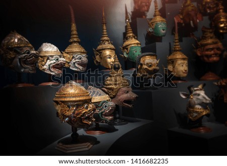 Thai handicraft mask head character from ramayana epic for thai khon art dancing collection set with dark background and low lighting.