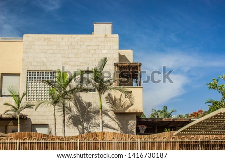 common living apartment cottage outside facade picture with palm trees and patio back yard space