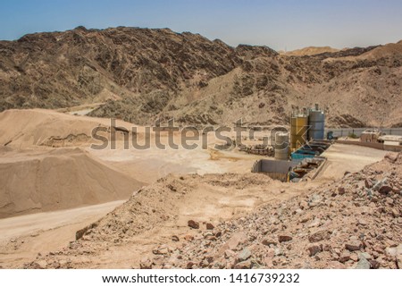 global warming and environmental pollution concept photography of awful abandoned and disabled rusty industrial factory with tank containers for some chemicals in desert quarry Middle East district