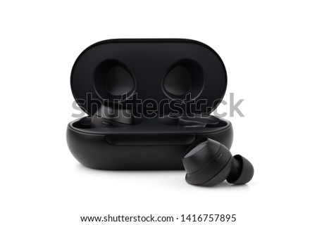 Wireless headphones on a white background. Headset close up in the charging case close-up. Royalty-Free Stock Photo #1416757895