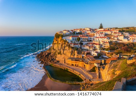 Typical village Azenhas do Mar on top of oceanic cliffs at sunset, Portugal Royalty-Free Stock Photo #1416774074