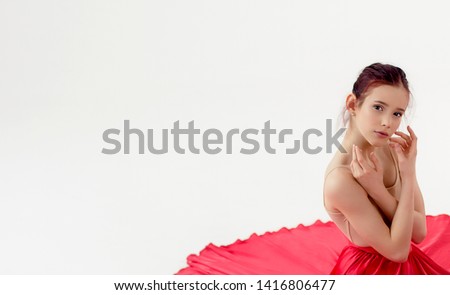 
girl dancer. In a beautiful red dress in motion