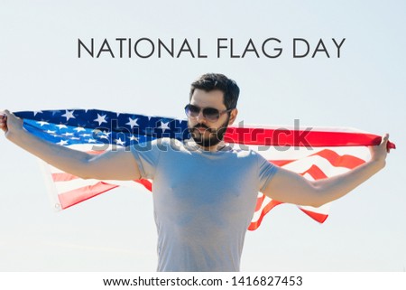 young man proudly  hold waving american USA flag. happy flag day text