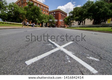 X LOCATES ON ELM ST DALLAS TEXAS WHERE PRESIDENT KENNEDY WAS SHOT WITH BOOK DEPOSITORY ON THE BACK Royalty-Free Stock Photo #1416842414
