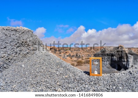 Conceptual Photo Picture of an Hourglass Object in the Dry Desert