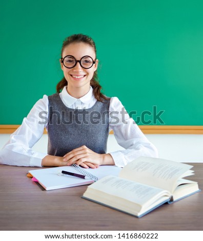Diligent student, ready to learn. Photo of girl in uniform, wearing glasses. Education concept
