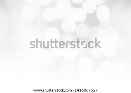 White bokeh light background. Abstract blurred shiny circle light for Christmas winter holiday festive celebration party, happy new year background and design, defocused, high key
