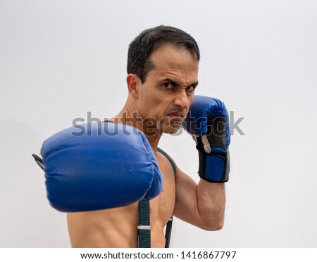 shirtless man with suspenders, boxing glove making fight poses