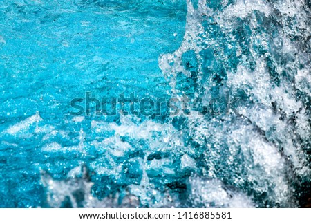 amazing blue turquoise water patterns of moving and splashing water
