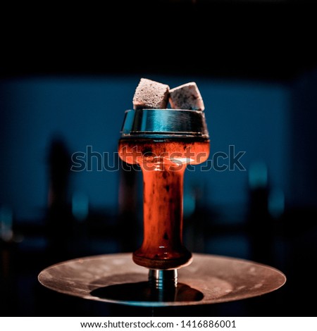 Process of making hookah for smoking. concept of smoking a hookah and having a good time. hookah bowl on the dark background of the bar. Toned image Royalty-Free Stock Photo #1416886001