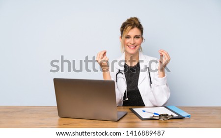 Blonde doctor woman making money gesture