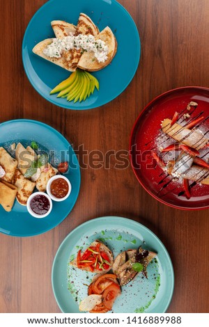 Assorted crepe with fruit and berries in a wooden rustic table