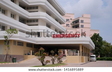 Modern hospital building with ambulance car and entrance to emergency room at hospital