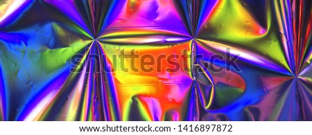 Photo of blur holographic foil. Trendy neon color.